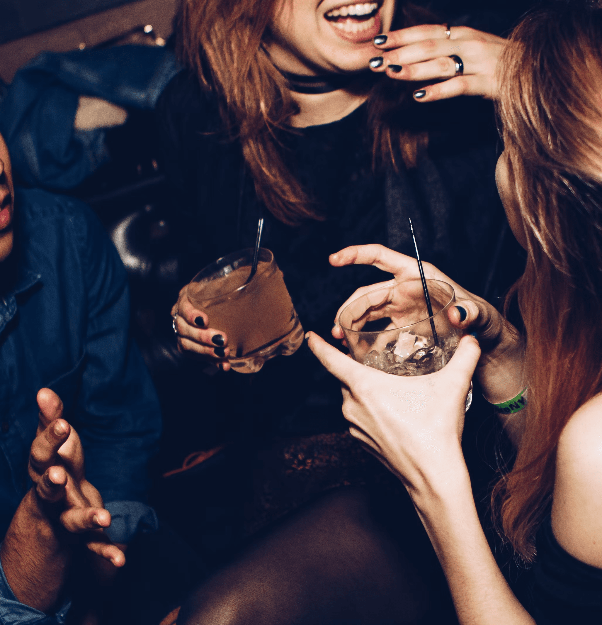 girls holding drinks in glass